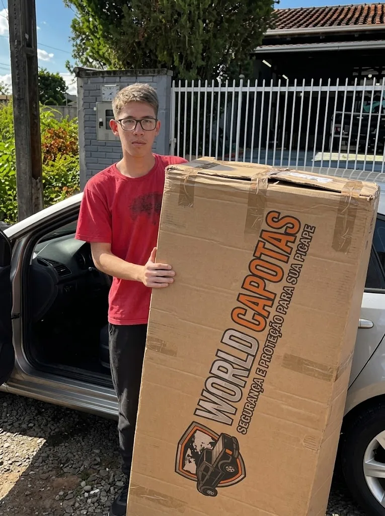 Cliente de t-shirt vermelha com a embalagem da encomenda World Capotas